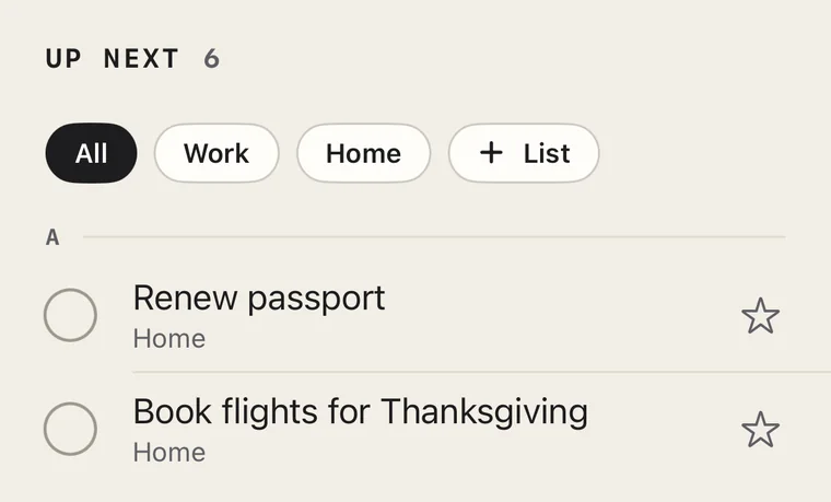 Up Next, 6 tasks, with list buttons All, Work, Home and + List, then the A priorities: Renew passport and Book flights for Thanksgiving, each with a circle on the left and a star on the right.